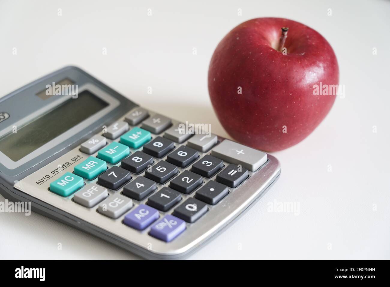 calculator and apple closeup Stock Photo Alamy