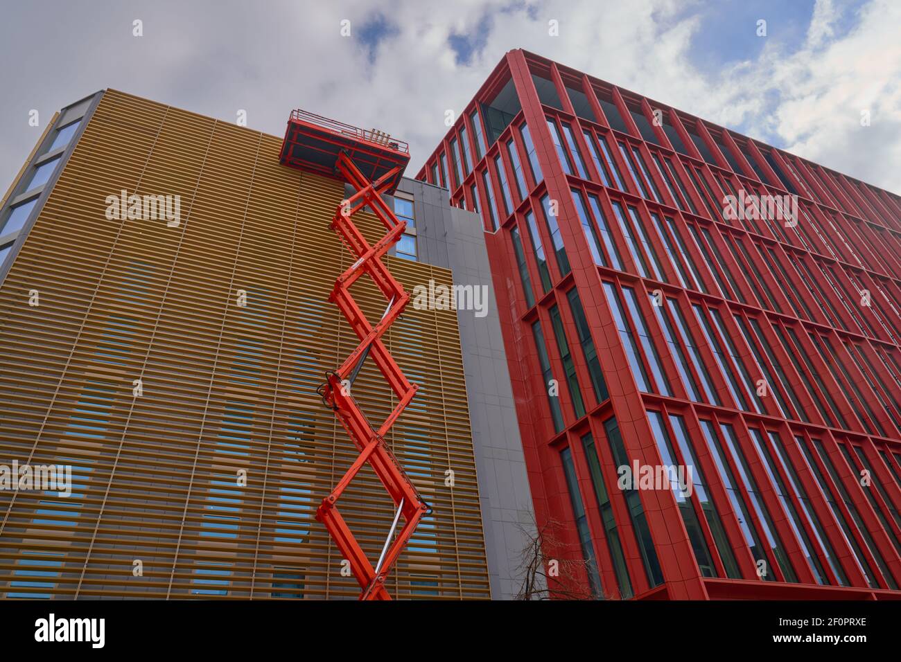 Large cherry picker platform on modern buildings in Manchester city centre Stock Photo
