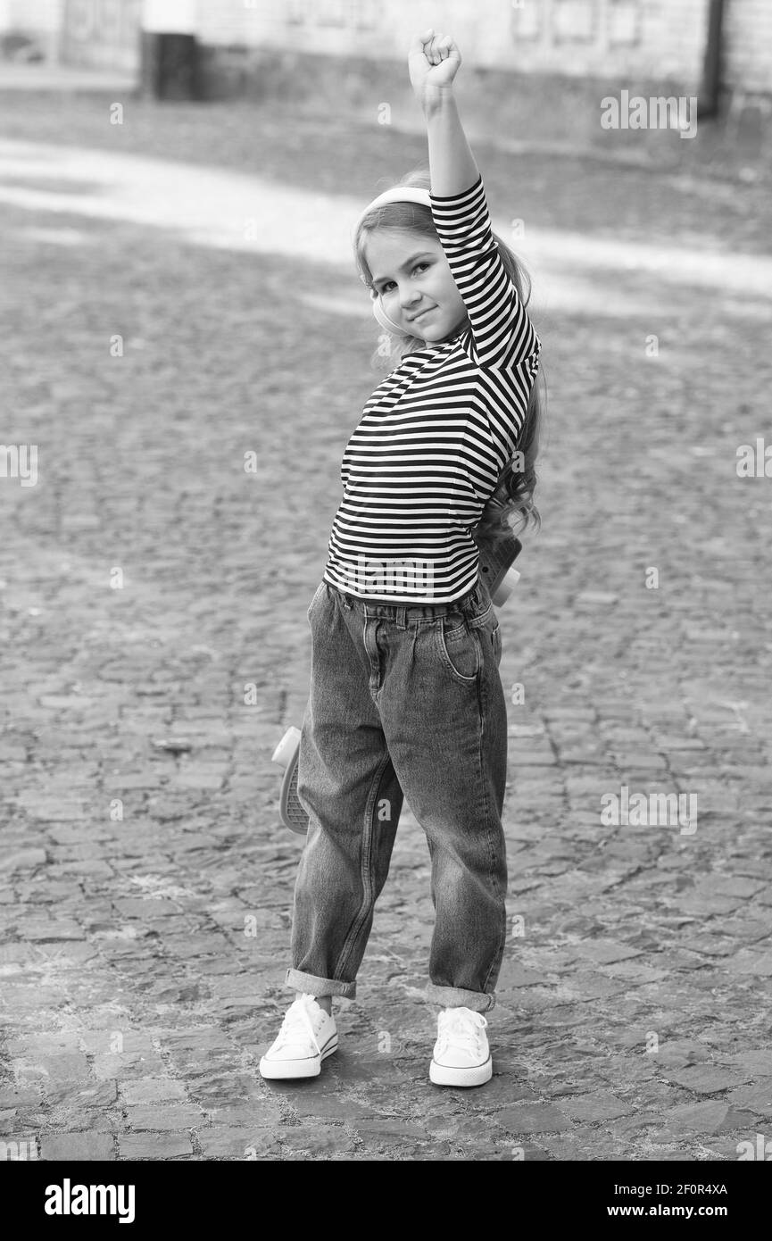 Strong performance. Proud skater hand with clenched fist. Small girl with penny board Power slide trick. Skateboarding and transportation. Fun physics activity. Strong and Stock Photo - Alamy