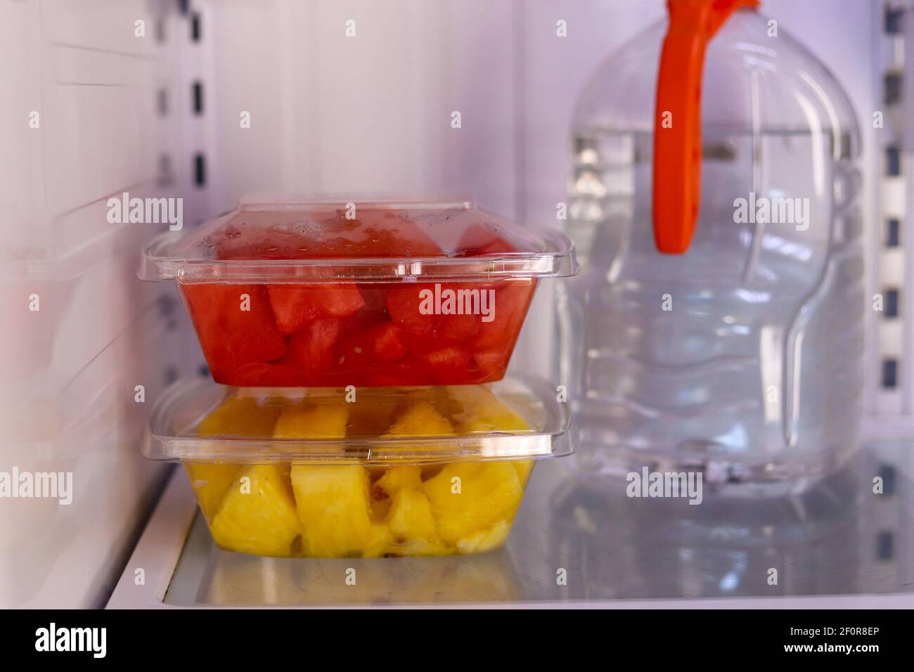 A close-up of freshly cut watermelon  and pineapples in a refrigerator Stock Photo