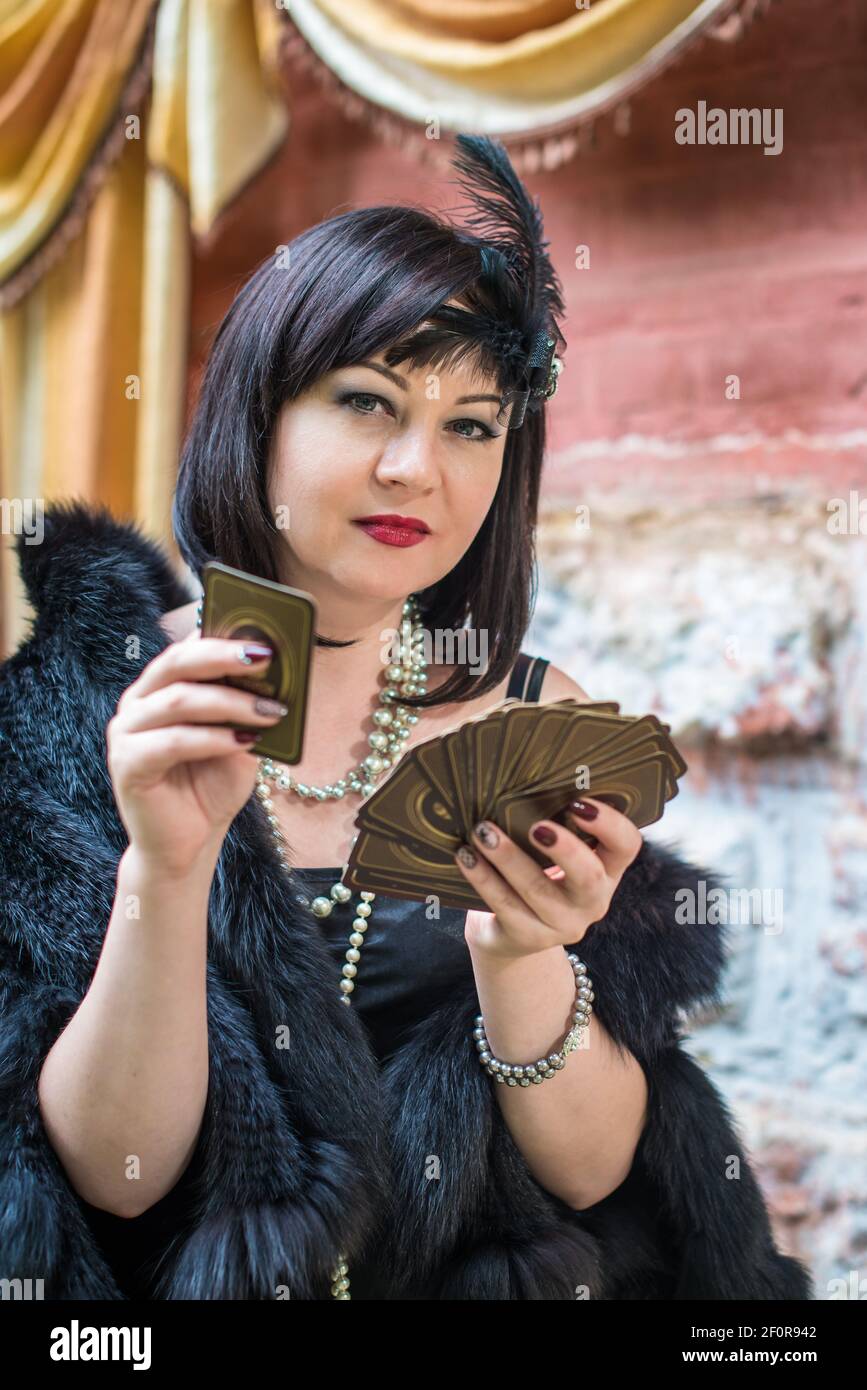 Beautiful retro woman holding playing cards Stock Photo Alamy