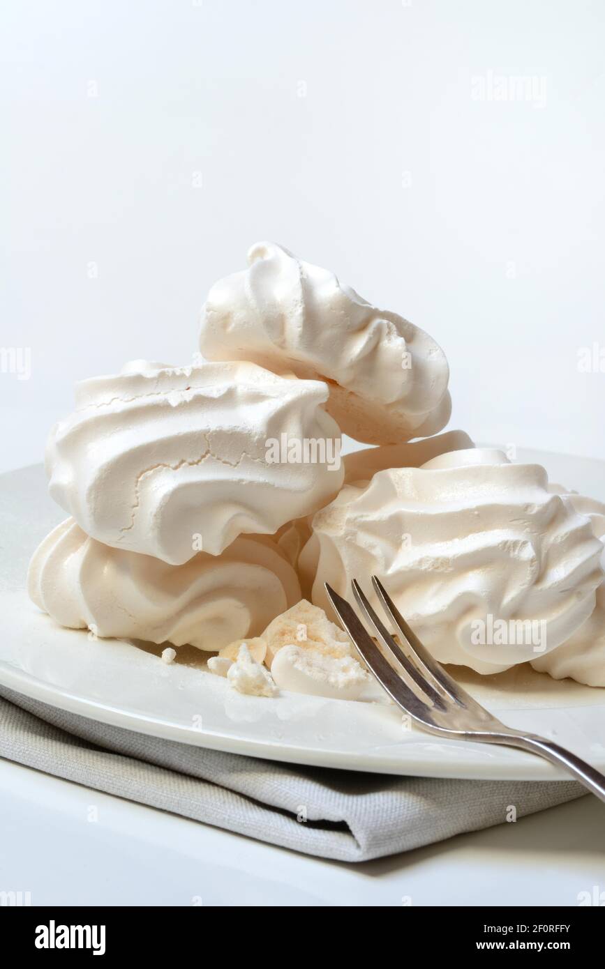 Meringue, meringues on plate with fork, Germany Stock Photo Alamy