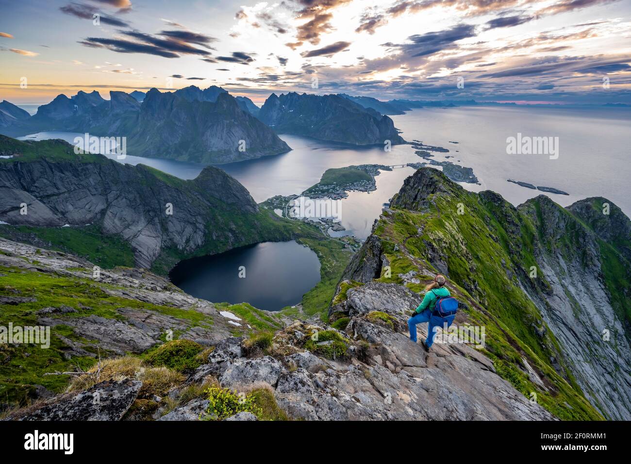 Evening atmosphere, young hiker on the ridge enjoying the view from ...