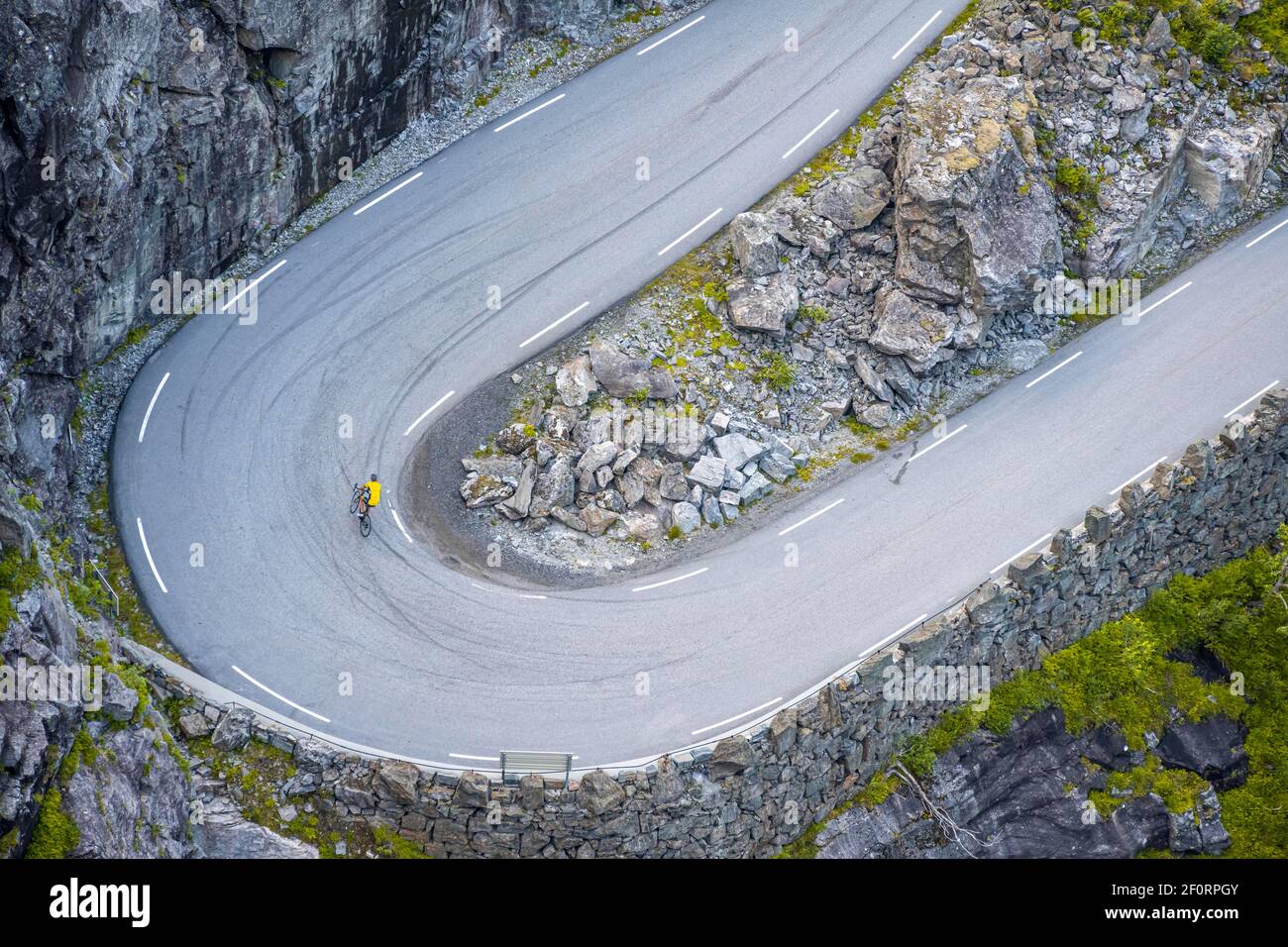 Single cyclist, hairpin bend at the mountain road Trollstigen, near ...