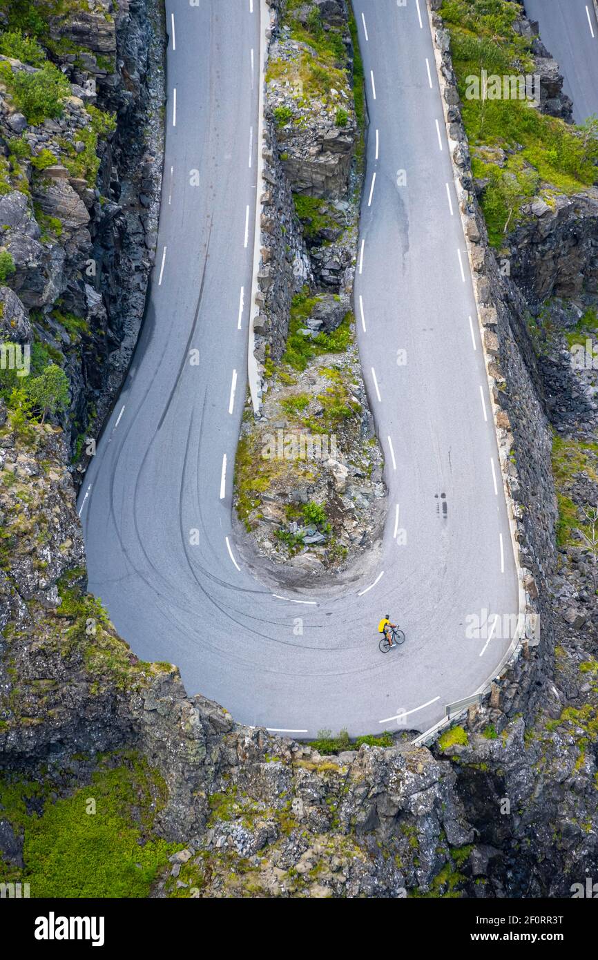 Single cyclist, hairpin bend at the mountain road Trollstigen, near ...