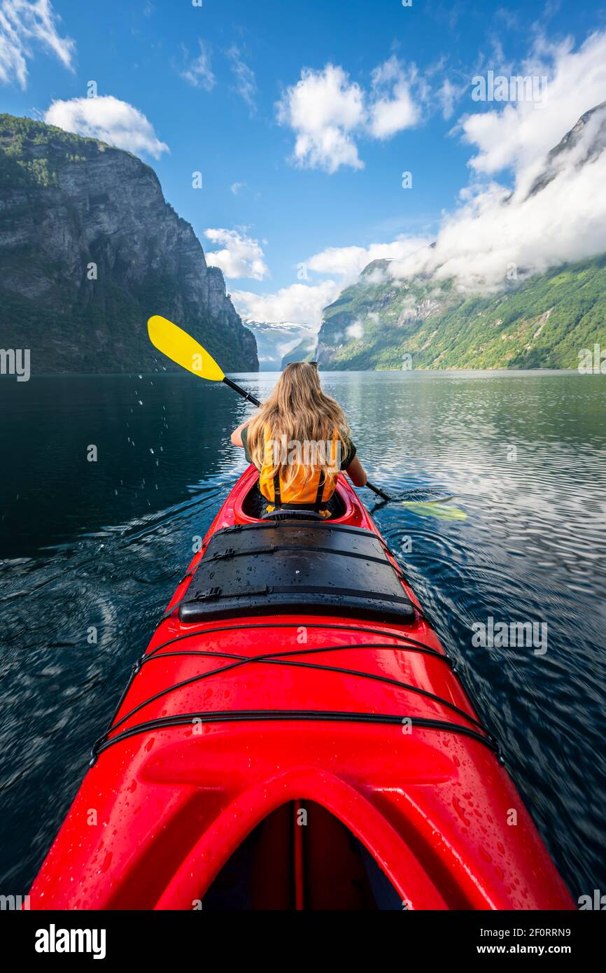 Young woman paddling in a kayak, Geirangerfjord, near Geiranger, Norway  Stock Photo - Alamy