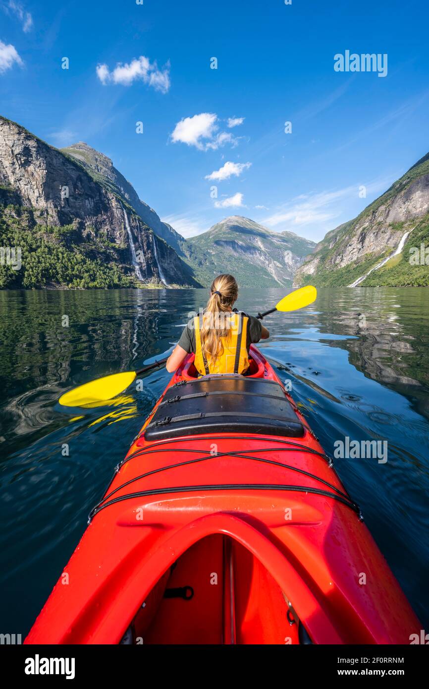 Young woman paddling in a kayak, Geirangerfjord, near Geiranger, Norway  Stock Photo - Alamy