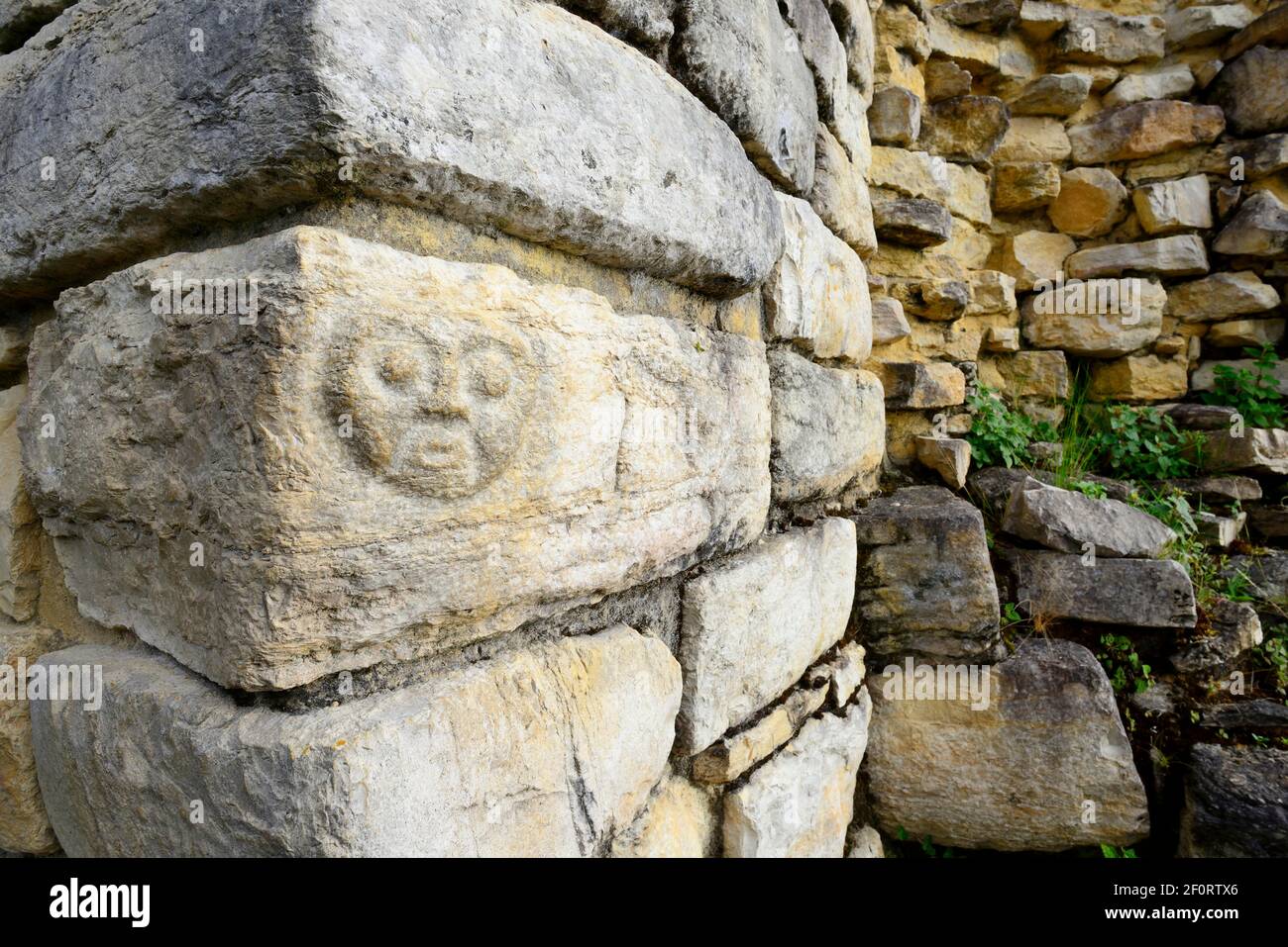 Face carved in stone at a ruin of the Chachapoyo culture, Kuelap, Luya province, Amazonas region, Peru Stock Photo