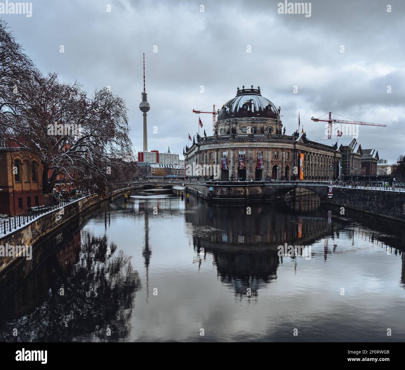 Beautiful winter view of snow covered Bode museum and UNESCO World Heritage Site Museumsinsel or Museum Island on Spree river, Berlin, Germany Stock Photo