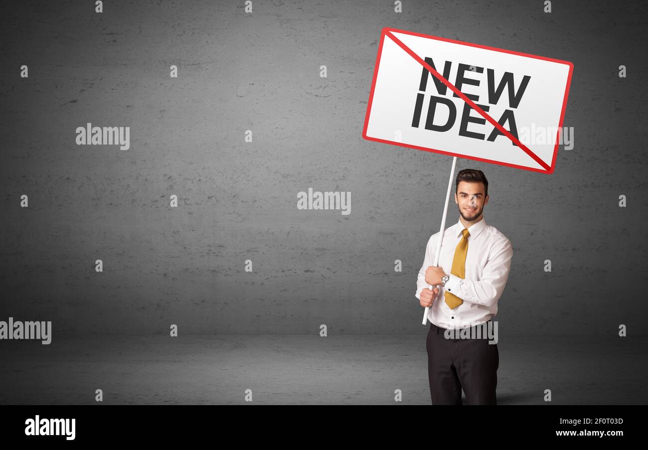 business person holding a traffic sign with NEW IDEA inscription, new idea concept Stock Photo