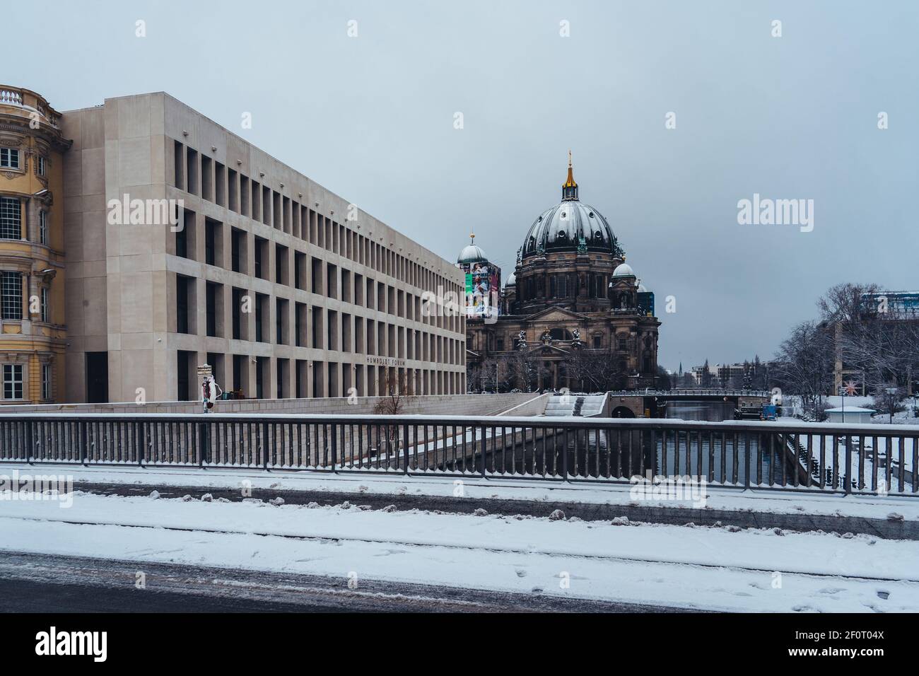 BERLIN, GERMANY - Feb 10, 2021: Snow covered Berlin Cathedral with Royal Castle or city palace and Humboldt Forum on a winter day. Stock Photo