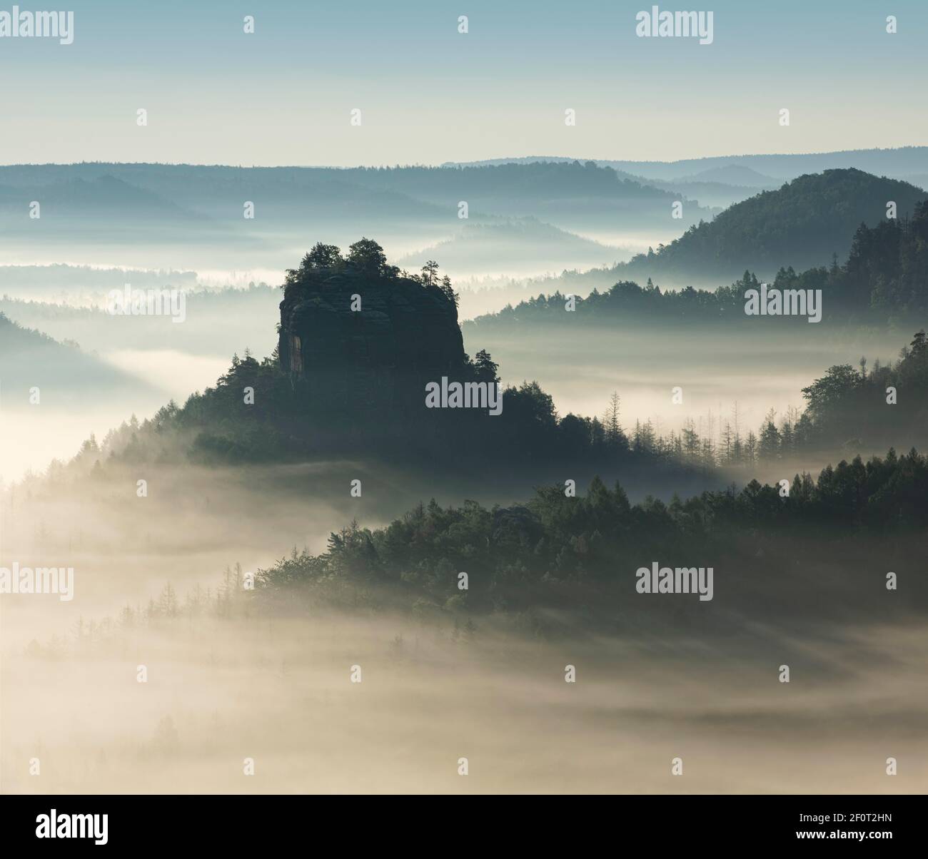 Morning atmosphere in the Elbe Sandstone Mountains, view of the Hintere Raubschloss or Winterstein, fog in the valley, Saxon Switzerland National Stock Photo