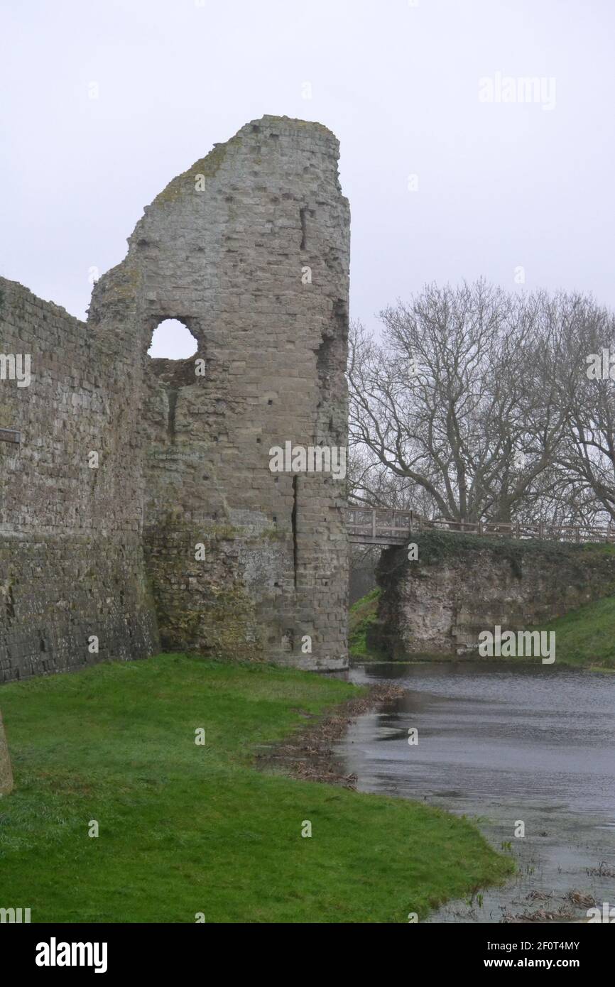 Pevensey Castle And Moat On A Wet Winters Day - Overcast Sky - Roman Fort - Medieval Gatehouse Entrance Turret - English Heritage - Sussex UK Stock Photo