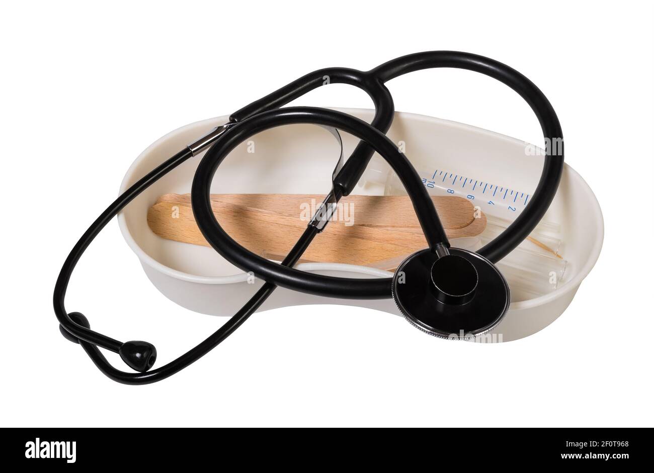 Black acoustic stethoscope and medical equipment. Diagnostic tool for heartbeat exam on plastic dish with syringe and wooden tongue depressors. Health. Stock Photo