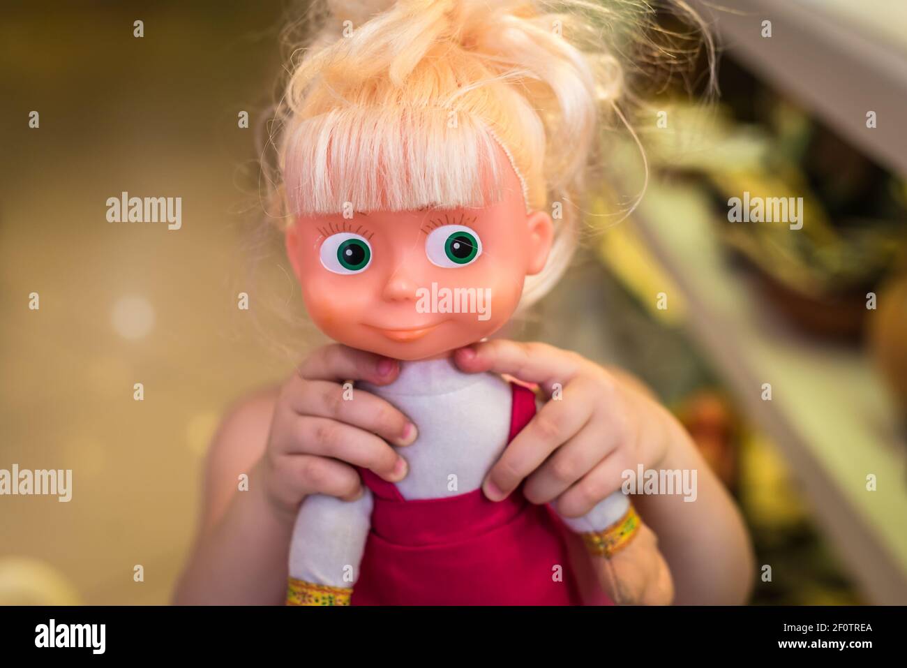 Baby hands hold the doll Stock Photo