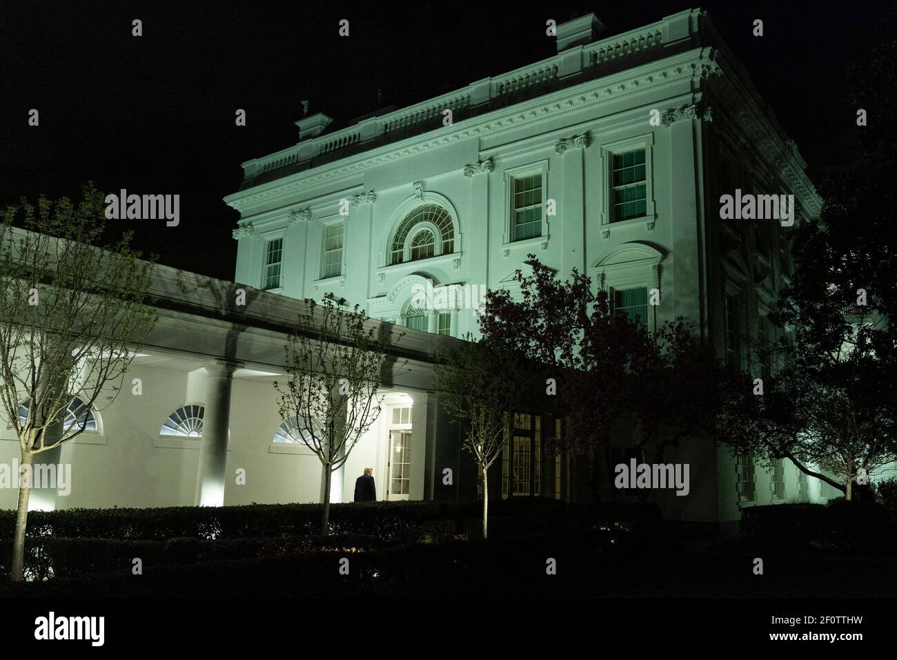 President Donald Trump walks along the West Wing Colonnade to the White House Residence following his address to the nation Wednesday evening March 11 2020. Stock Photo