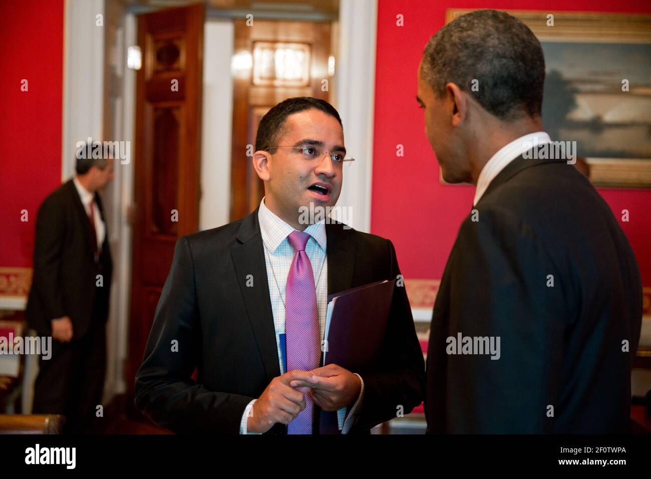 President Barack Obama talks with Gautam Raghavan in the Red Room of the White House June 13 2013. Stock Photo