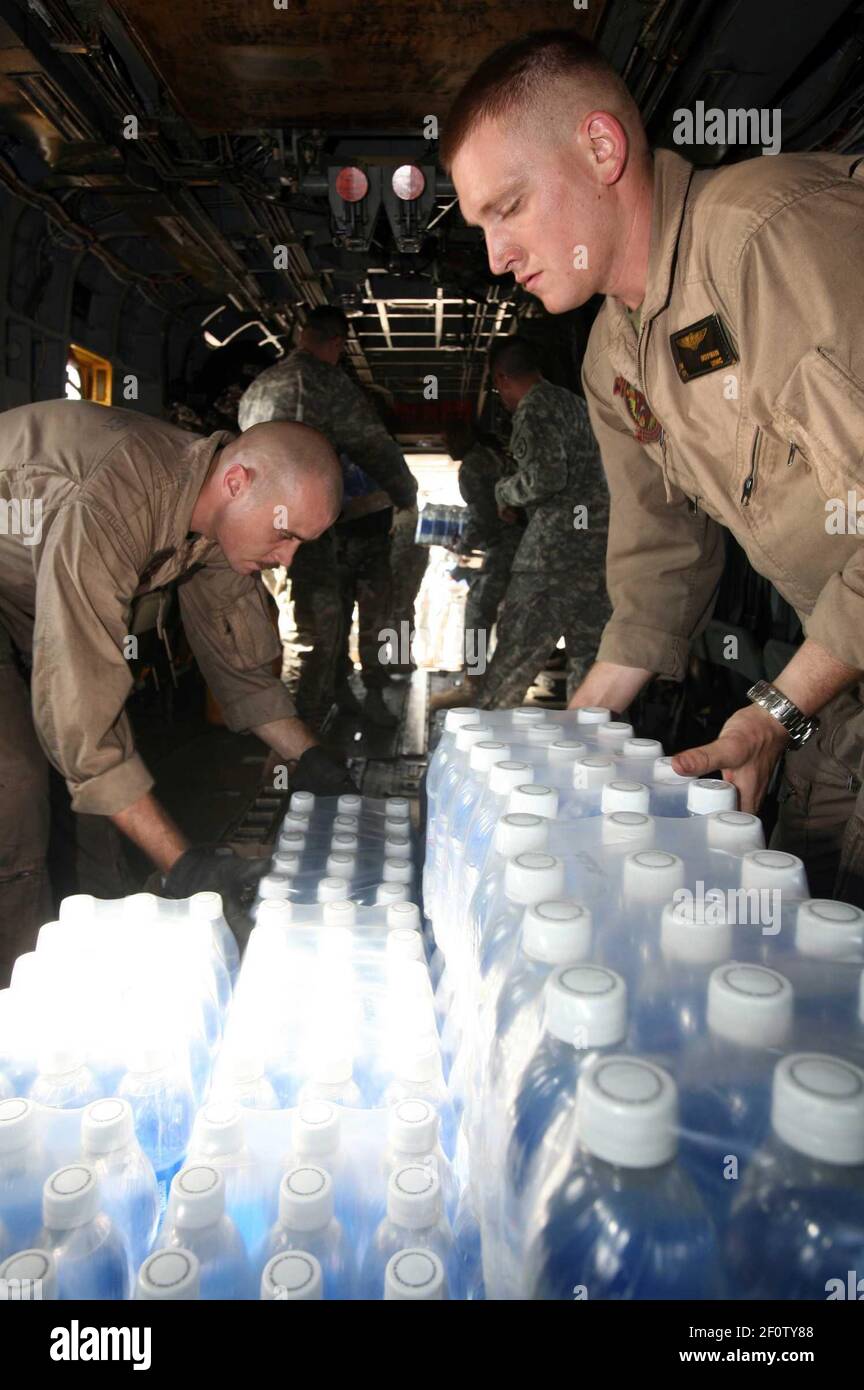 26 November 2007 - Dhaka, Bangladesh - Cpl. Eric M. Dorfman, right, and Cpl. Nicholas M. Moneymaker load cases of bottled water onto a CH-53E Sea Stallion transport helicopter. The two Marines are flight line mechanics assigned to Marine Medium Helicopter Squadron (HMM) 261, the aviation combat element of the 22nd Marine Expeditionary Unit (MEU). The amphibious assault ship USS Kearsarge (LHD 3) and the 22nd MEU are providing humanitarian aid to the victims of Cyclone Sidr, which tore through Bangladesh Nov. 15. Photo Credit: Peter R. Miller/US Navy/Sipa Press/0711262104 Stock Photo