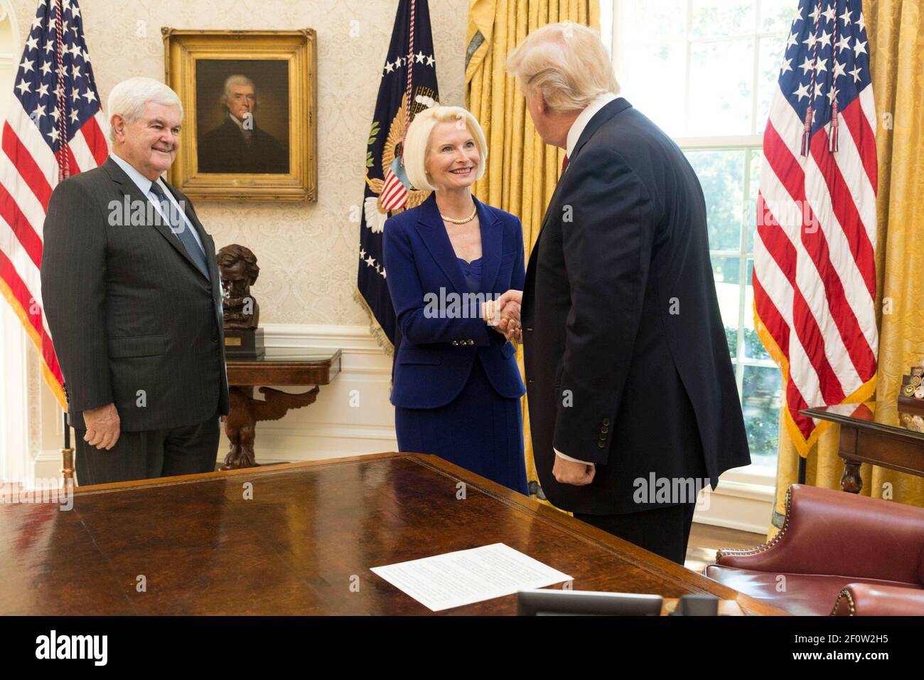 President Donald Trump greets Newt and Callista Gingrich in the Oval Office at the White House Tuesday October 24 2017 prior to the swearing in ceremony of Callista Gingrich as U.S. Ambassador to the Holy See in Washington D.C. Vice President Mike Pence attends. Stock Photo