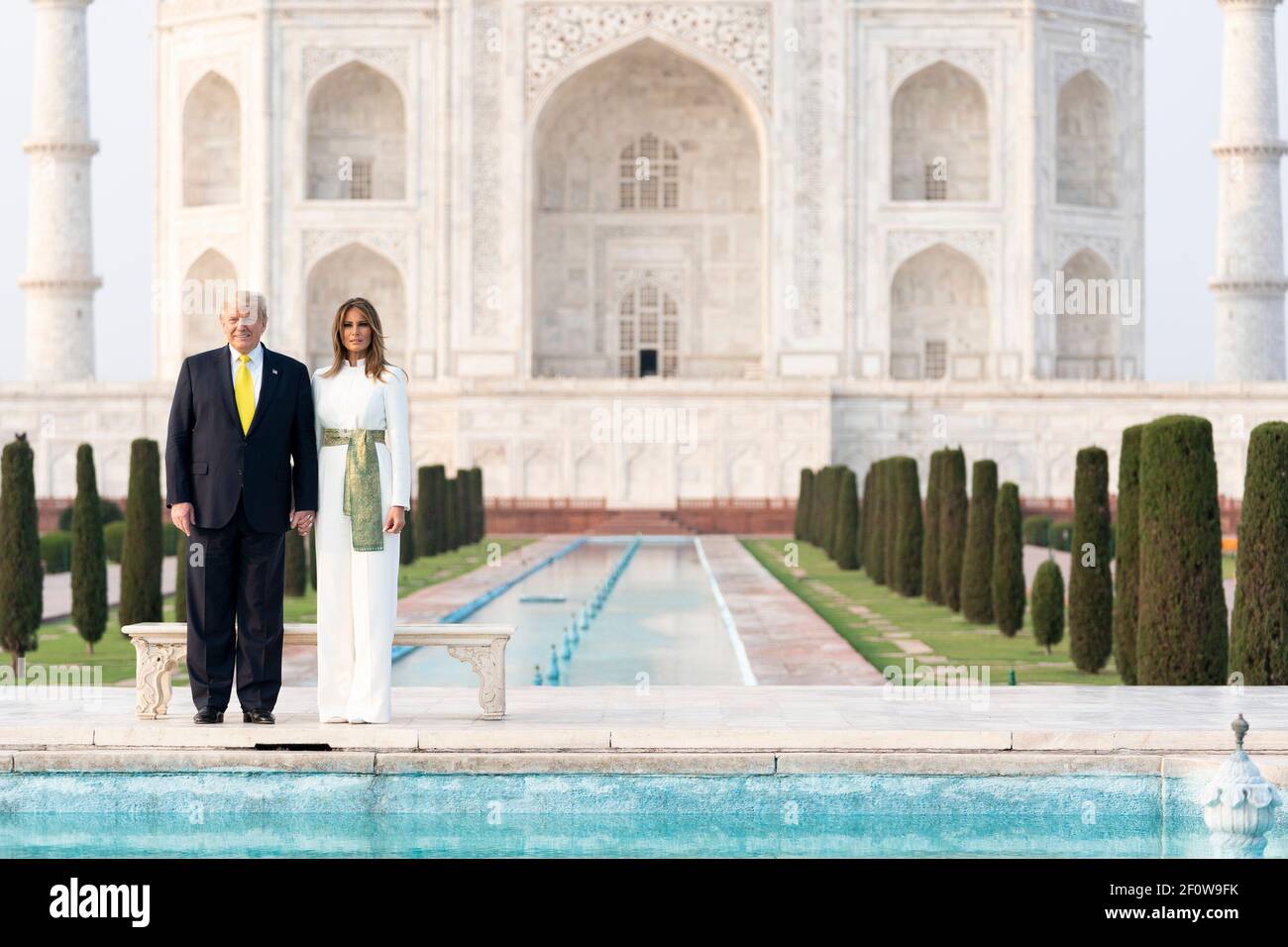 President Donald Trump and First Lady Melania Trump pose for a photo before the reflecting pool of the Taj Mahal Monday Feb. 24 2020 in Agra India. Stock Photo