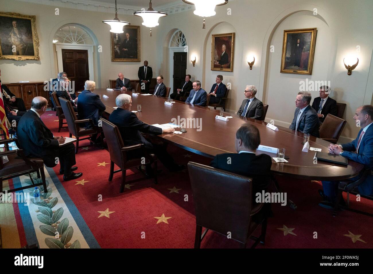 President Donald Trump joined by Vice President Mike Pence meets with tourism industry executives to discuss the health care and economic responses to the coronavirus (COVID-19) outbreak Tuesday March 17 2020 in the Cabinet Room of the White House. Stock Photo