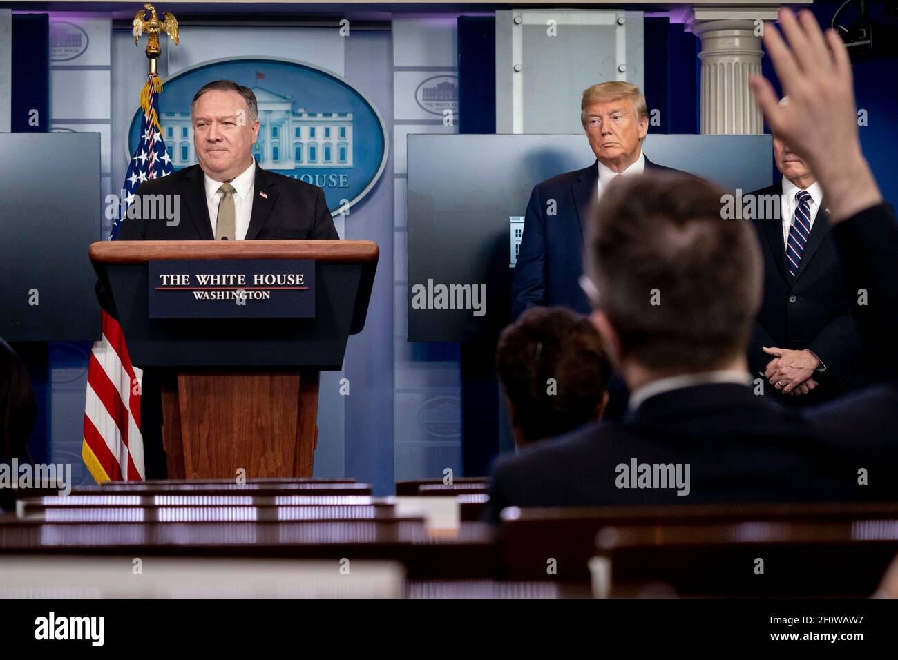 President Donald Trump and Vice President Mike Pence listen as Secretary of State Mike Pompeo announces that since January the State Department has brought back some 50000 Americans stranded overseas due to the coronavirus outbreak during the coronavirus update briefing Wednesday April 8 2020 in the James S. Brady Press Briefing Room of the White House. Stock Photo