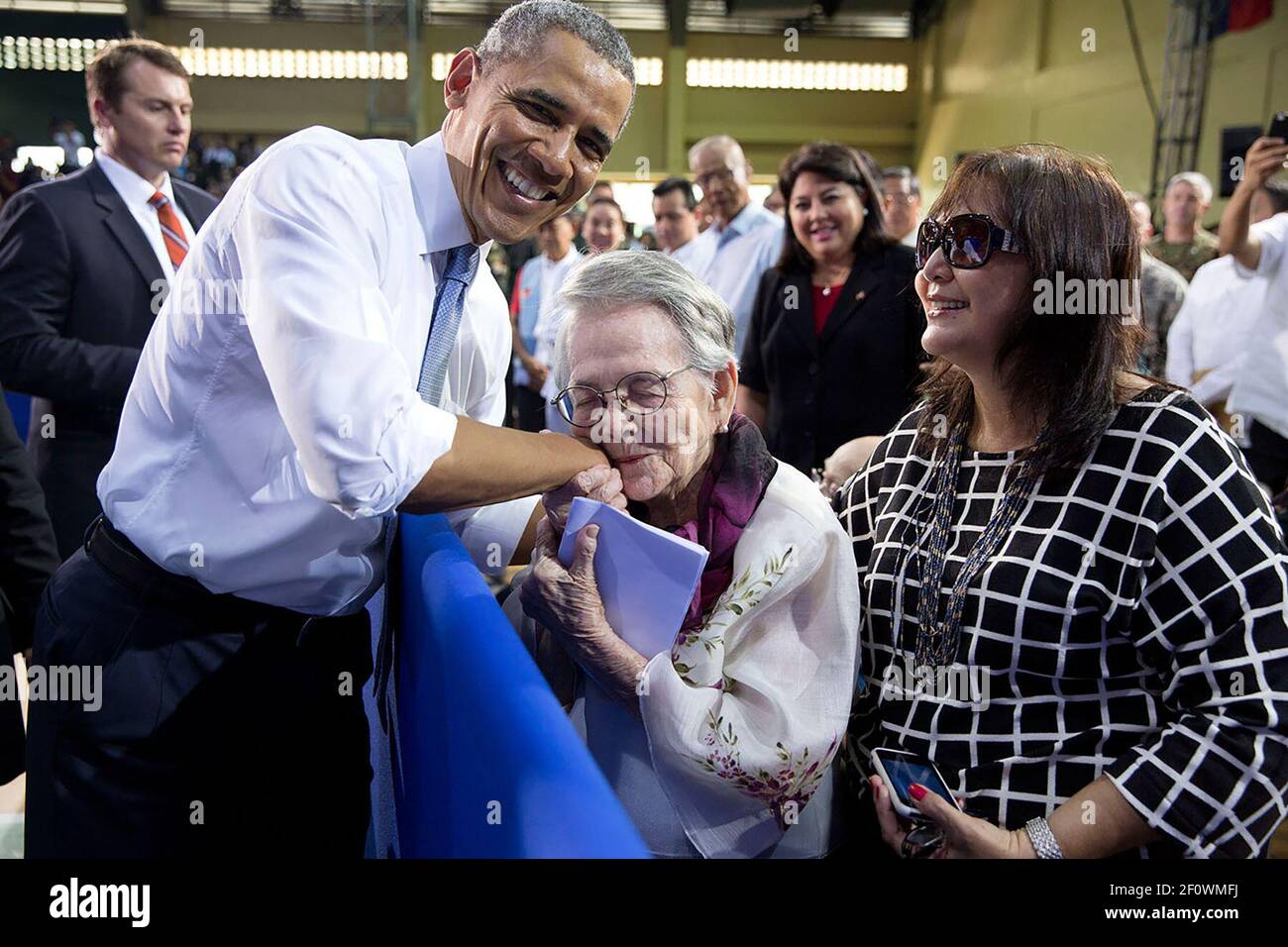 Carolina Garcia Delfin, 94, a Filipina nurse who fought in the resistance against Japanese forces during World War II, kisses President Barack Obama after he mentioned her in his remarks to American and Philippine troops at Fort Bonifacio in Manila, Philippines, April 29, 2014. Stock Photo