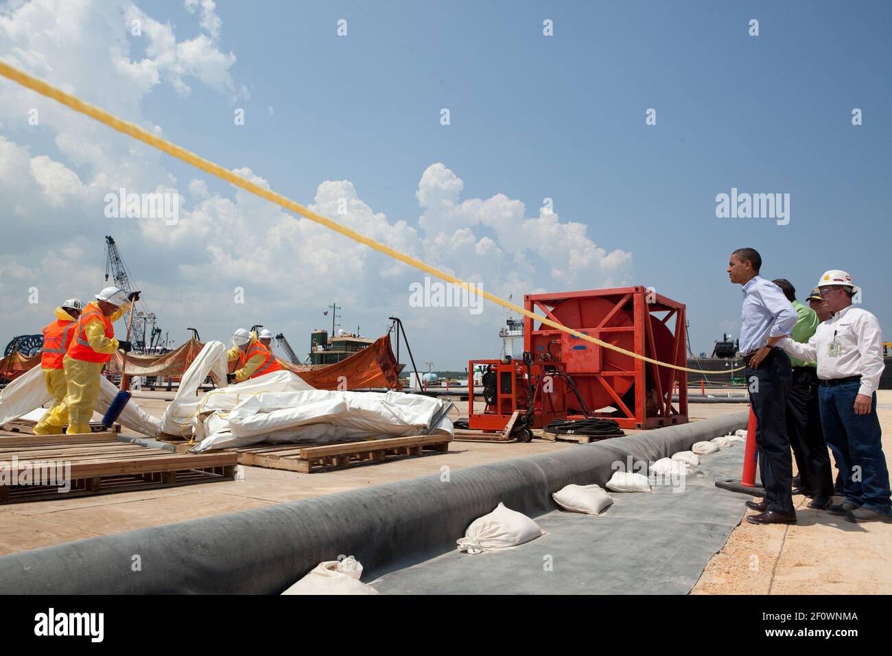 President Barack Obama observes operations at the Theodore Staging Facility in Theodore, Ala., June 14, 2010, where oil containment boom and other equipment is cleaned, decontaminated, and repaired in aftermath of BP Oil Spill Stock Photo