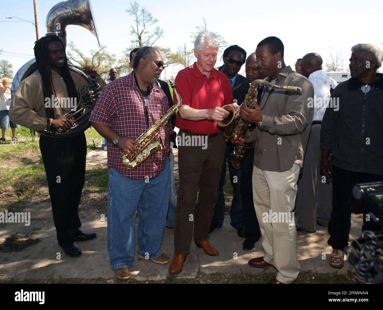 16 March 2008 - New Orleans, Louisiana, Lower 9th ward - Former President Bill Clinton talks saxophones and enjoys a rousing performance by the Lucky 8 Brass Band before he leaves the area. Clinton was in town for the 'Make a Difference, Make a Commitment' clean up of the neighbourhood devastated by Hurricane Katrina. The massive clean up project was organised by Brad Pitt's Make it Right Foundation aided by the Clinton Global Initiative. Photo Credit: Charlie Varley/Sipa Press/pittclintonone.026/0803171349 Stock Photo