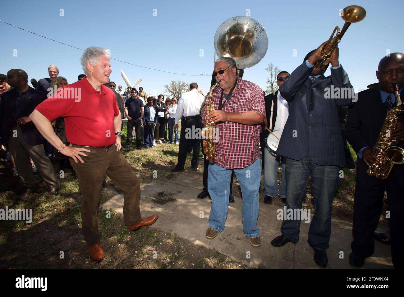 16 March 2008 - New Orleans, Louisiana, Lower 9th ward - Former President Bill Clinton talks saxophones and enjoys a rousing performance by the Lucky 8 Brass Band before he leaves the area. Clinton was in town for the 'Make a Difference, Make a Commitment' clean up of the neighbourhood devastated by Hurricane Katrina. The massive clean up project was organised by Brad Pitt's Make it Right Foundation aided by the Clinton Global Initiative. Photo Credit: Charlie Varley/Sipa Press/pittclintonone.028/0803171350 Stock Photo