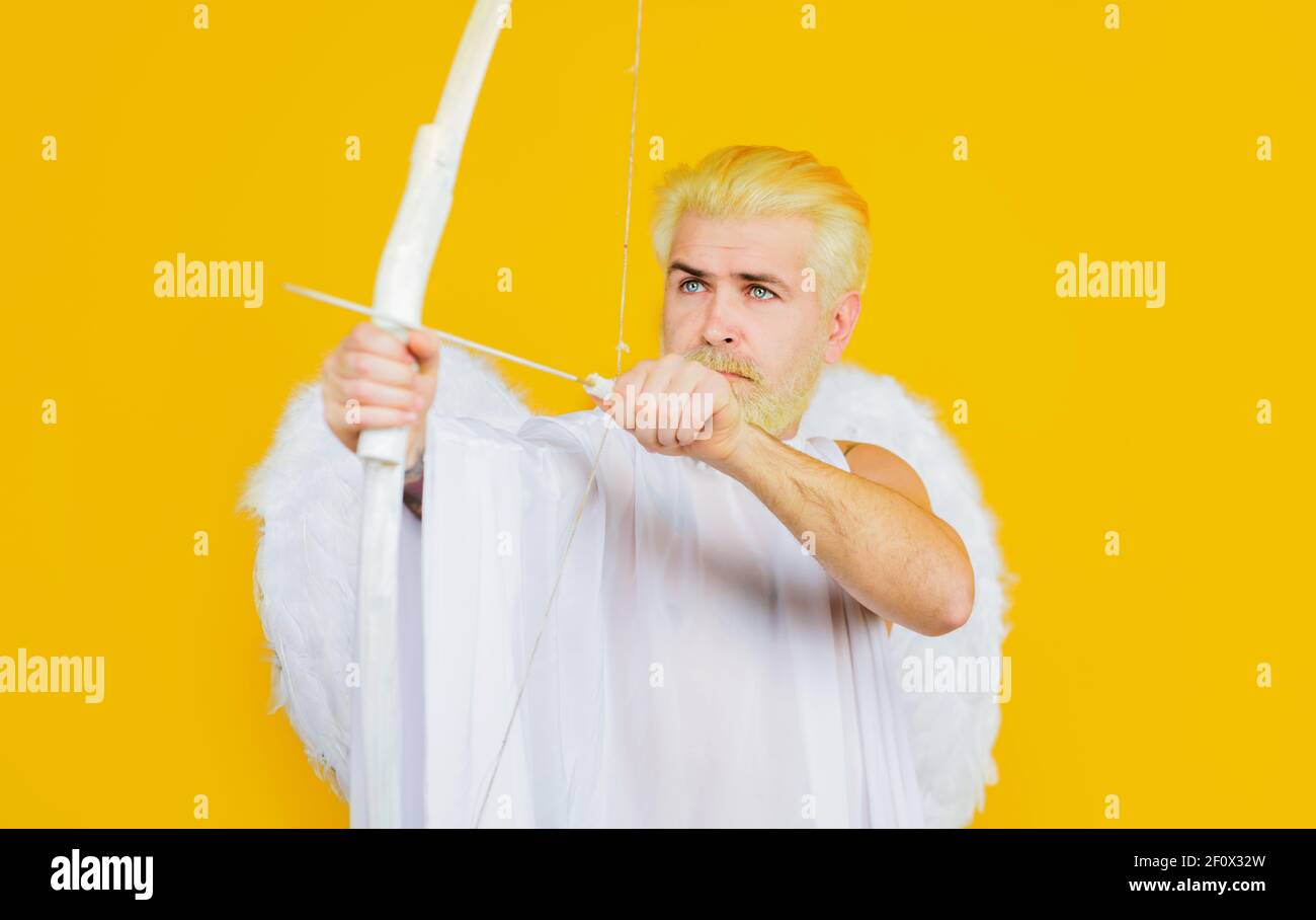 Cupid throws love arrow with bow. Valentines Day concept. Arrows of love. Angel with bow and arrow. Stock Photo