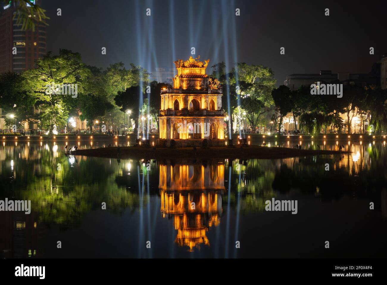 Night view of historical landmark Turtle Tower on Hoan Kiem Lake in central Hanoi, Vietnam. Stock Photo