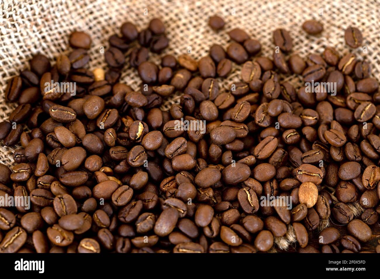 Coffee beans on burlap background Stock Photo