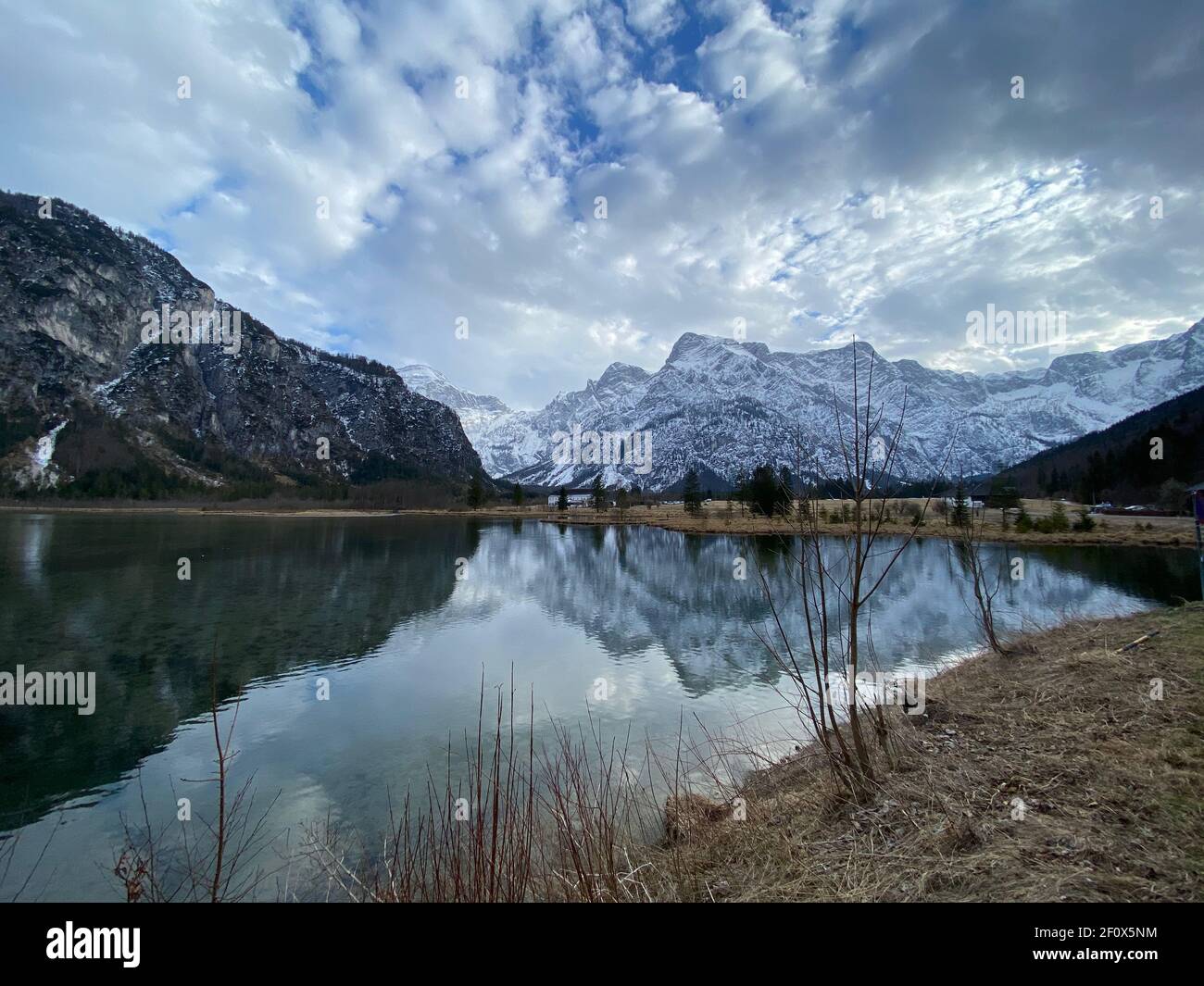 Reflections of a sunset over alpine mountain lake Almsee in Austria Stock Photo