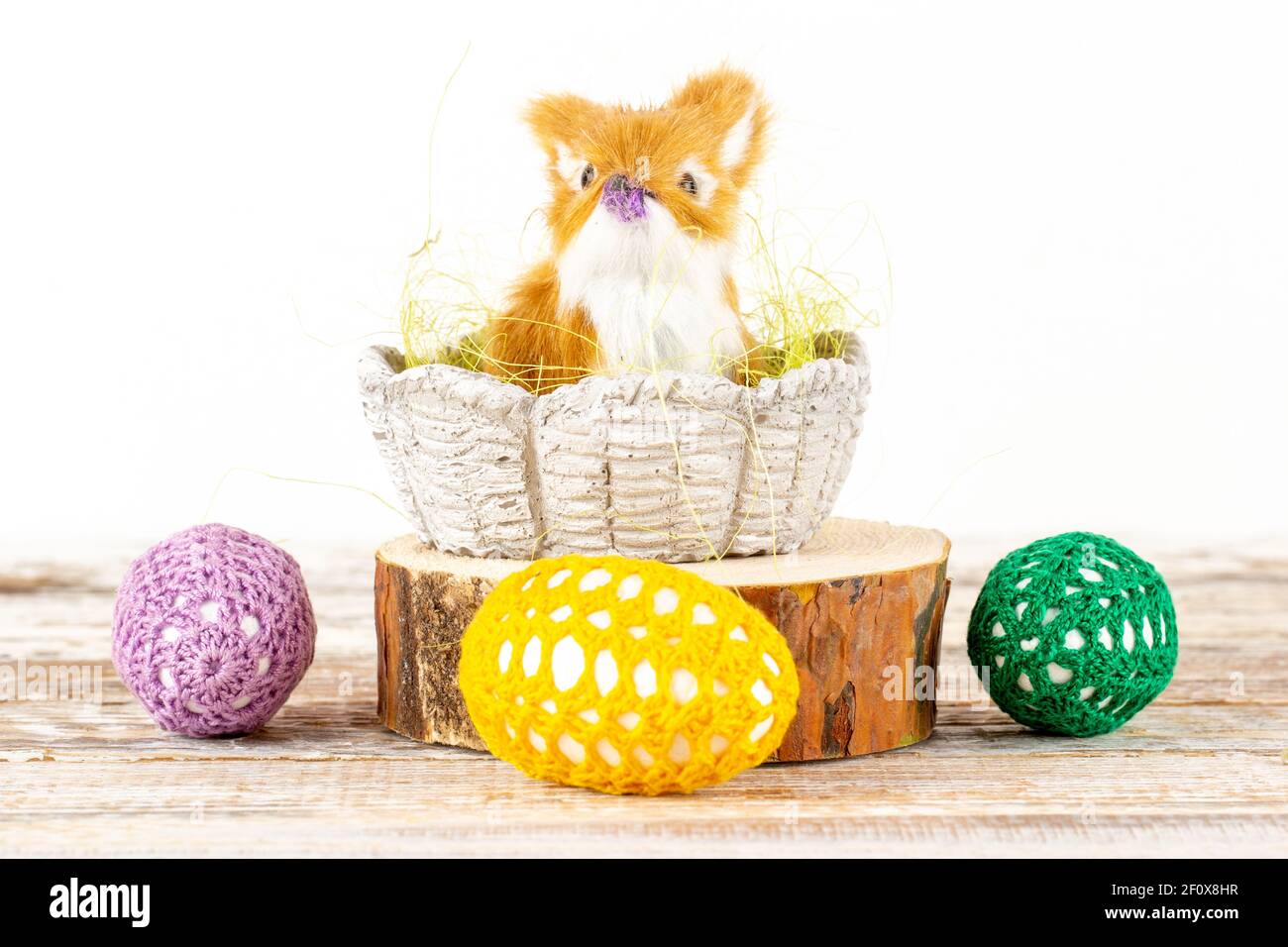 Easter bunny in a basket surrounded by Easter eggs Stock Photo