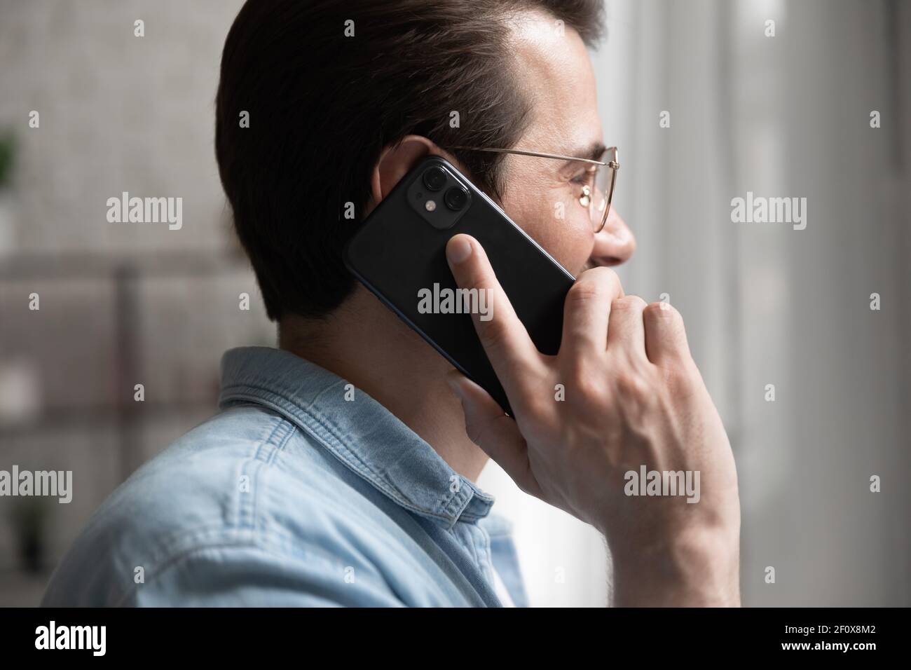 Cropped side shot of male expert consulting customer by phone Stock Photo