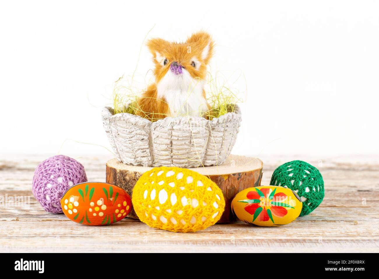 Easter bunny in a basket surrounded by Easter eggs Stock Photo