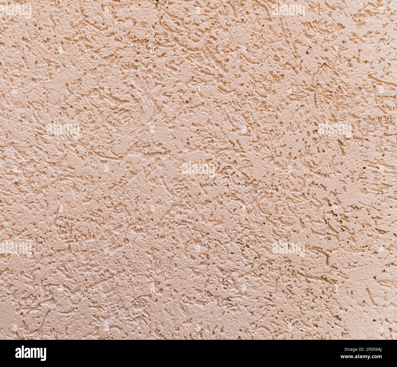 Background from decorative facing plaster on pink wall Stock Photo