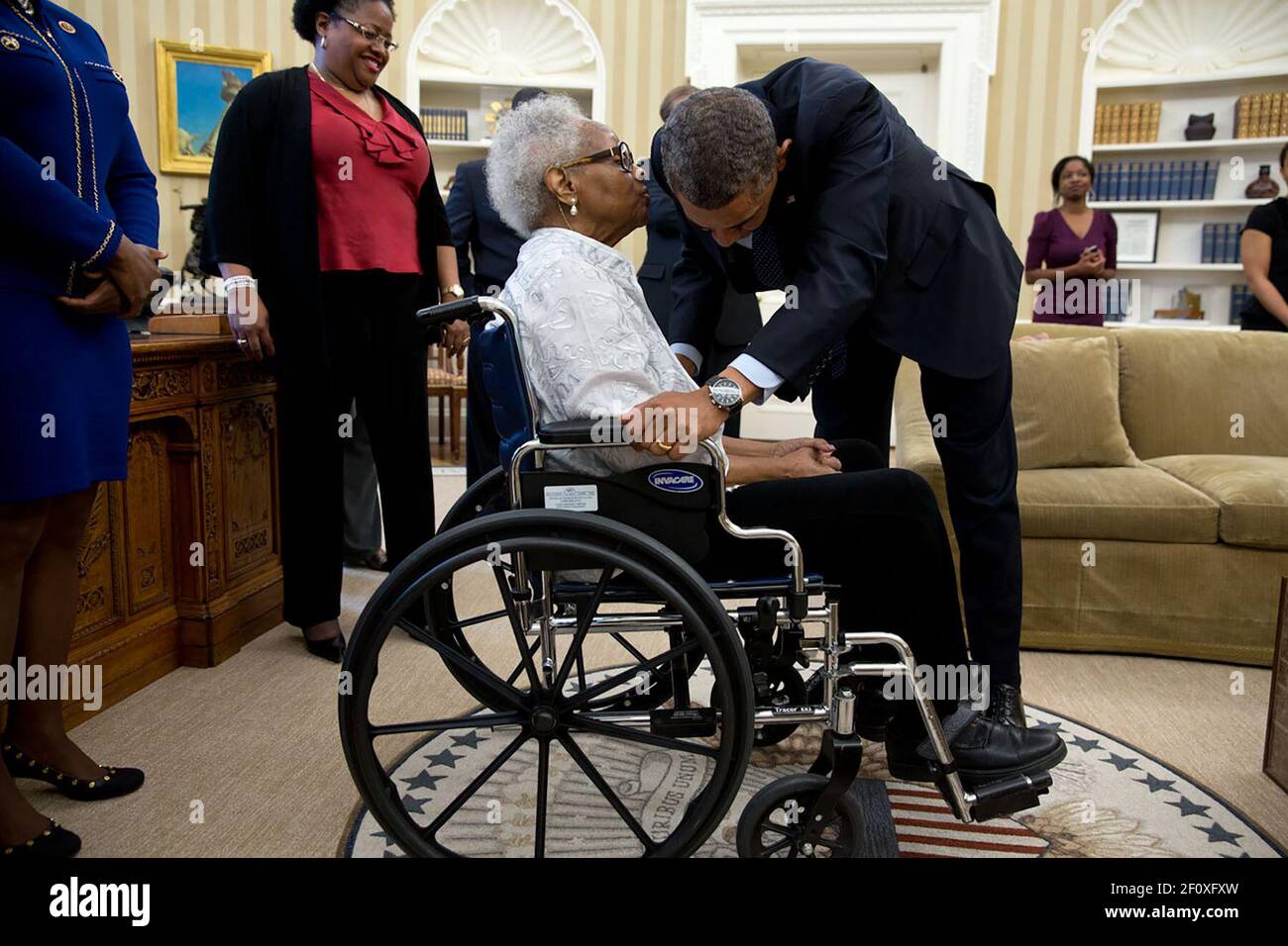 Thelma Maxine Pippen McNair, mother of Denise McNair, whispers to President Obama after he signed H.R. 360, which provided for the presentation of a congressional gold medal to commemorate the lives of the four young African American victims of the bombing of the Sixteenth Street Baptist Church in Birmingham, Alabama, in September 1963. McNair's daughter was one of the victims.' ca. May 24, 2013 Stock Photo
