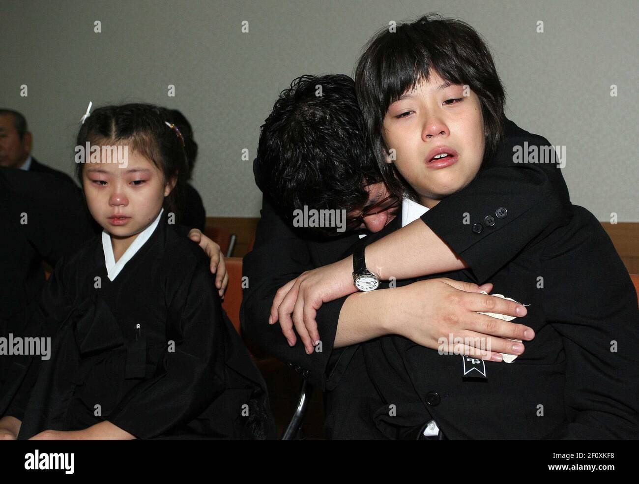 16 August 2008 - Kimhae, South Korea : South Korean sun Hwang jun-yeob  (right) and daughter Hwang Da-young (left), cry climber disaster Hwang  Dong-jin, 45 year, during his funeral ceremony at a