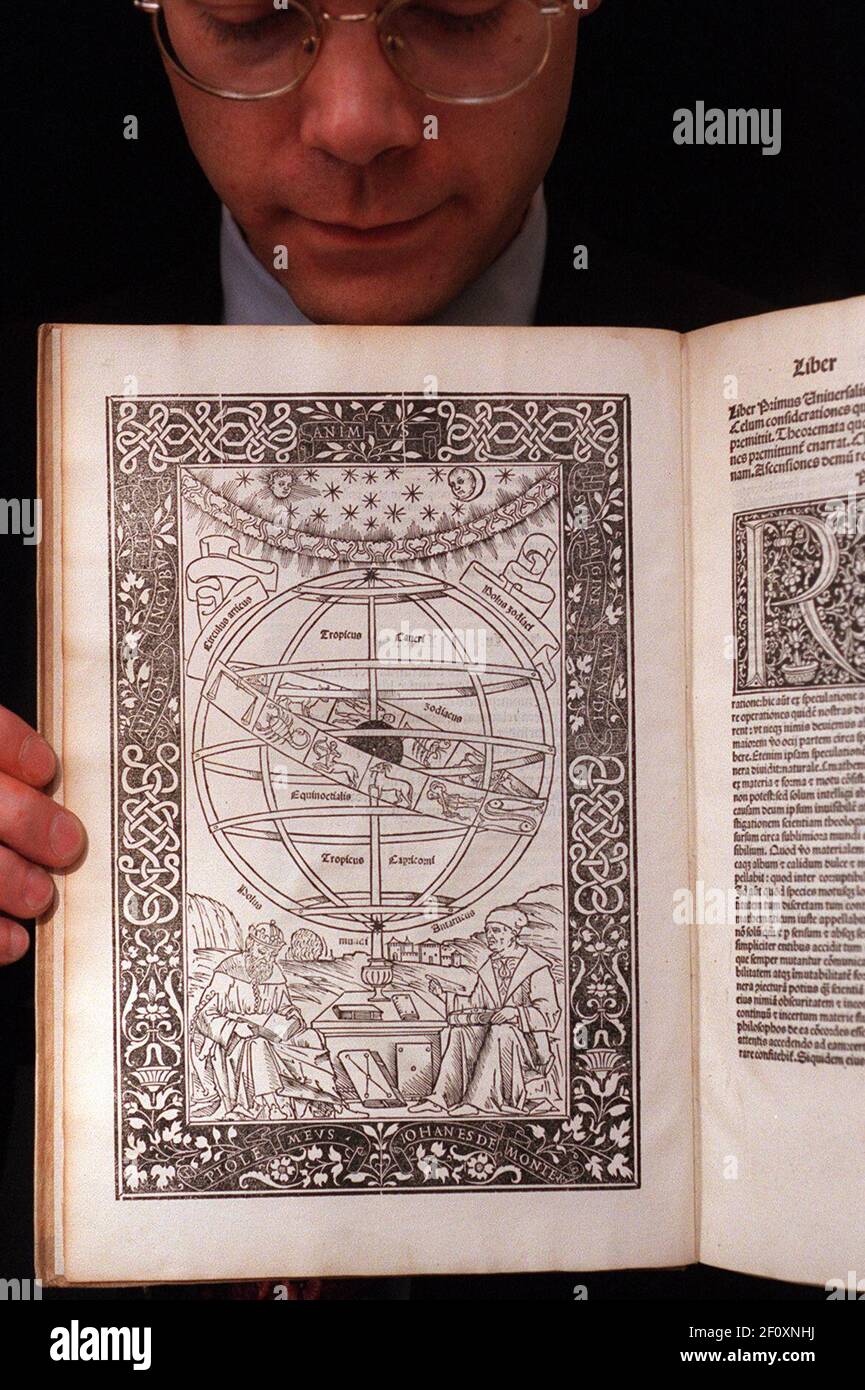 'PRINTING AND THE MIND OF MAN'., AN AUCTION AT CHRISTIES.MARK JAMES, A SPECIALIST IN THE BOOK DEPARTMENT, IS HOLDING A COPY OF 'EPYTOMA IN ALMAGESTUM PTOLEMAEI' BY REGIOMONTANUS. EST. ¿15,000-¿20,000 Stock Photo