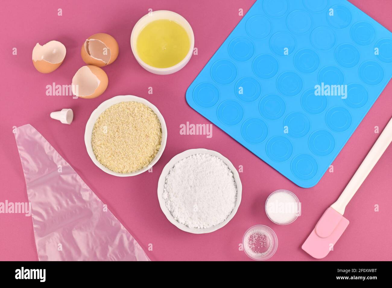 Ingredients for making homemade French Macaron sweets including powdered sugar, ground almonds, egg white, salt and baking tools Stock Photo