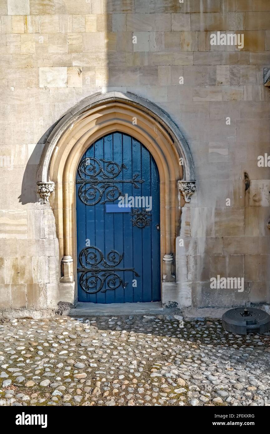 Ornate door, half in light and half in shade, of a historic building in the city of Norwich Stock Photo