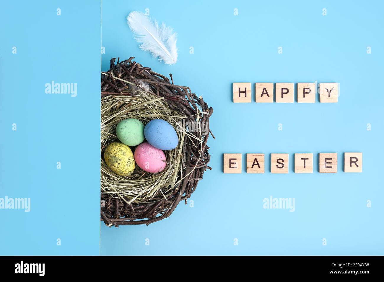 Blue background with painted easter egg nest flat lay Stock Photo - Alamy
