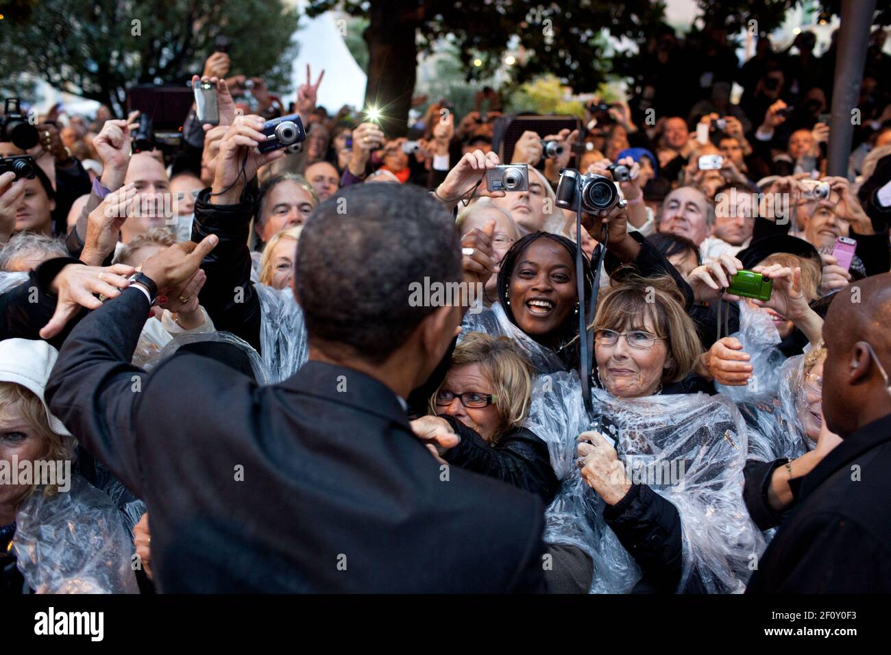 President Barack Obama greets people following a ceremony to honor the French and American Alliance, at a World War I Memorial at the Hotel de Ville in Cannes, France, Nov. 4, 2011 Stock Photo