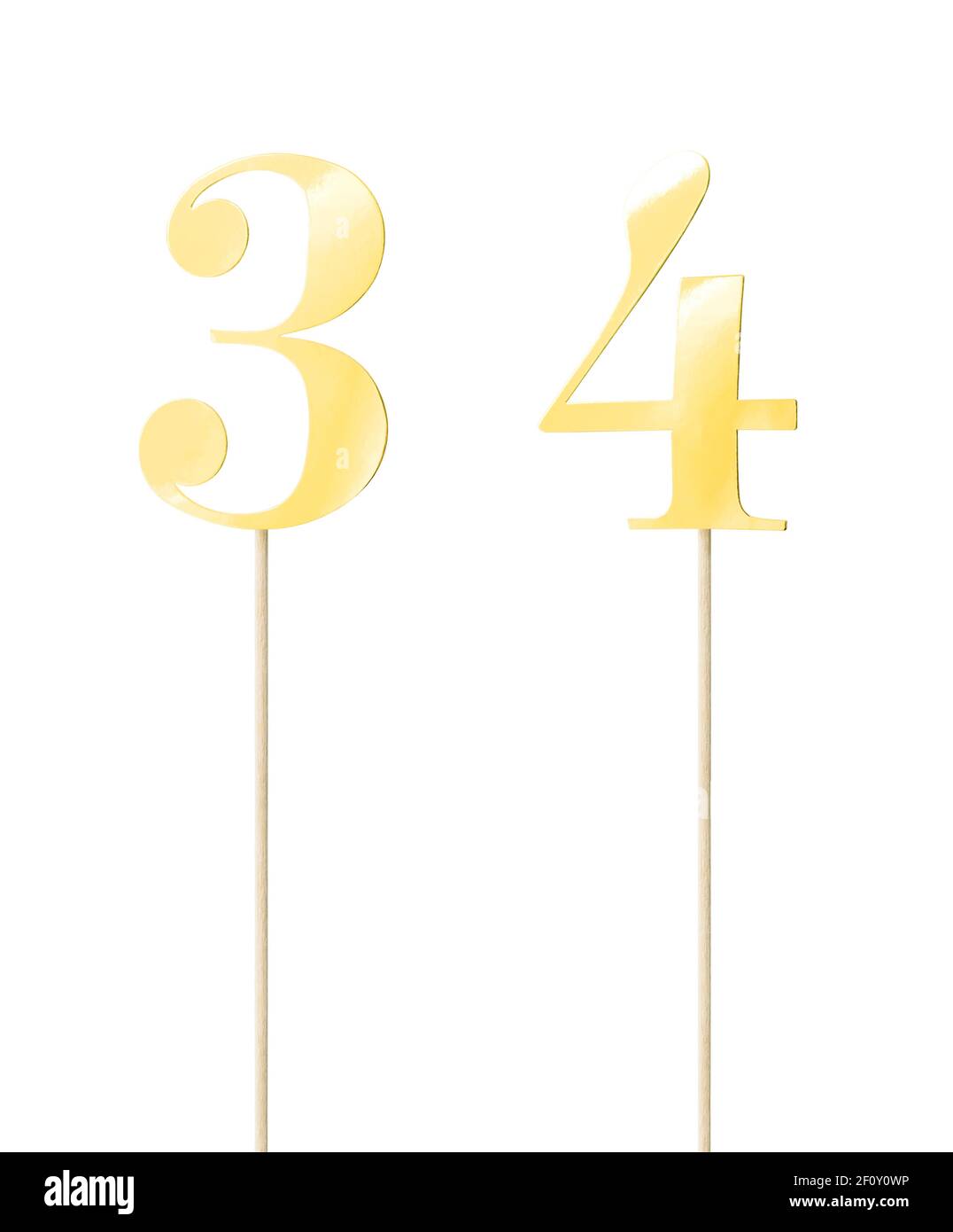 Shiny gold  topper cake paper numbers signs (three; four) on stick isolated on white background. Clipping path included. Stock Photo