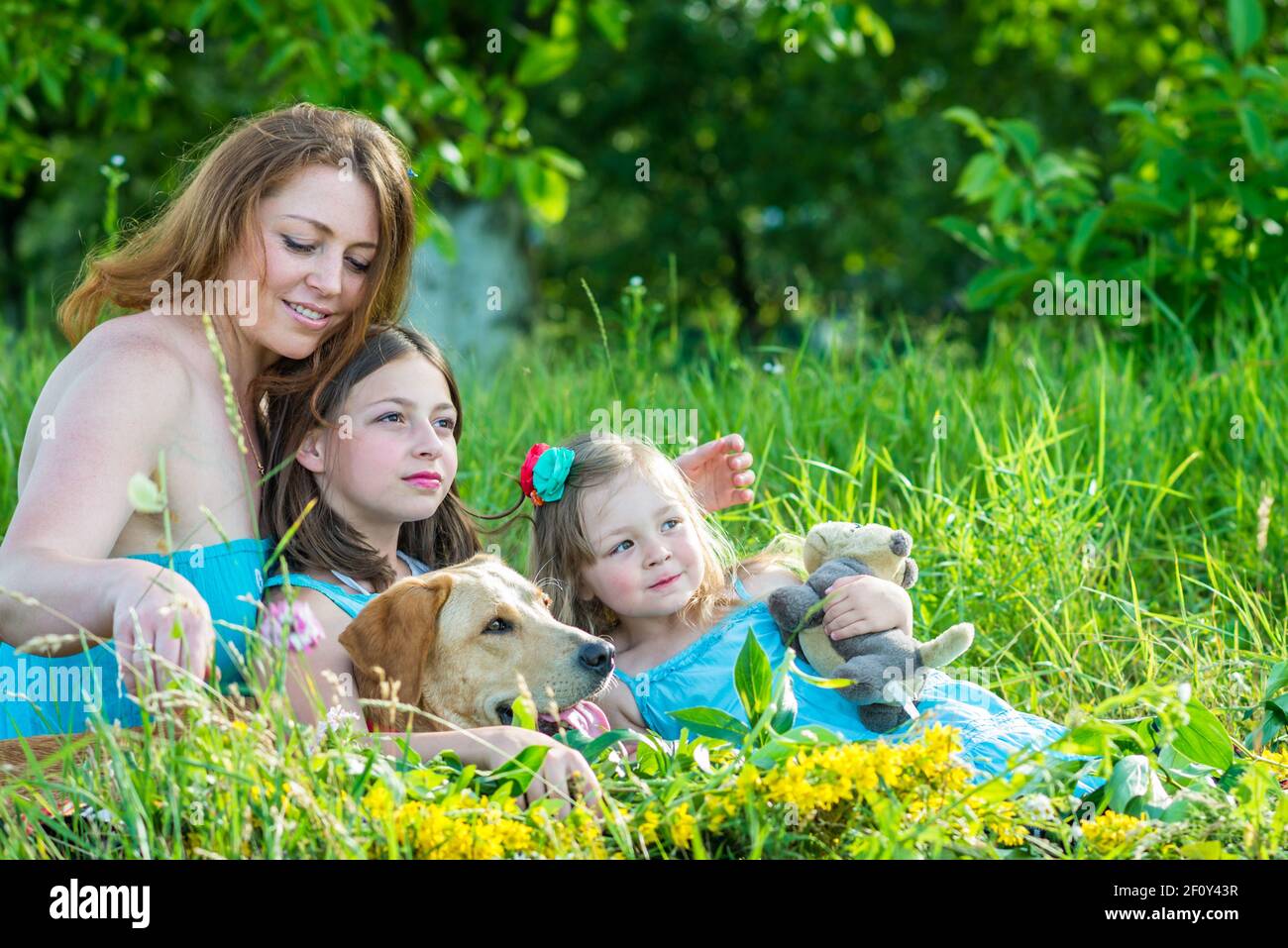 Mom with two daughters and dog Stock Photo