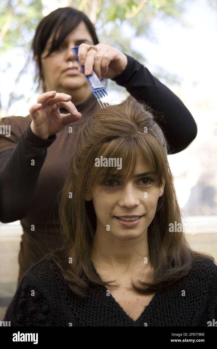 26 October 2008 - Brooklyn, New York - Esther Melamed puts on the Sarah P's  wig on ReneeK. Georgie, a 30-year-old sheitel shop in in Orthodox Jewish  neighborhoods like Brooklyn's Borough Park,