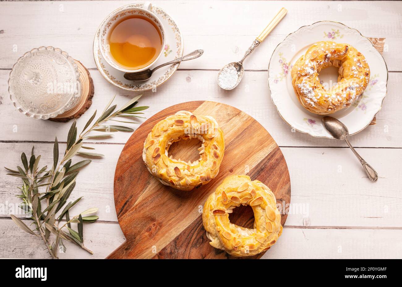 Small pastry Paris Brest in an old plate on a white wooden table Stock Photo Alamy