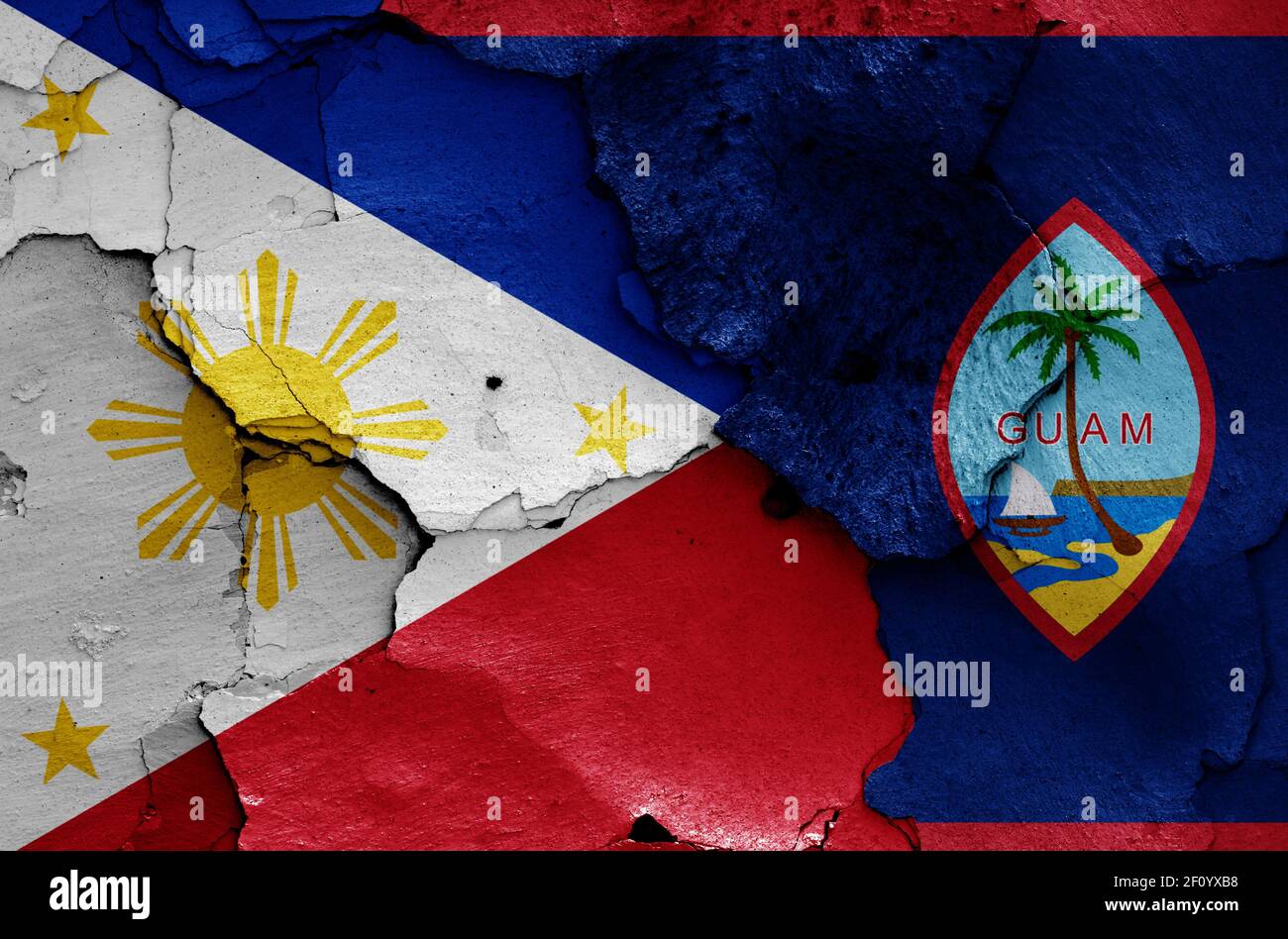 flags of Philippines and Guam painted on cracked wall Stock Photo